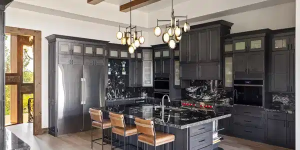 Image 4: Designed for both everyday living and large-scale entertaining, the chef's kitchen features professional-grade appliances, abundant custom cabinetry, and an oversized gathering island. Image 4: Designed for both everyday living and large-scale entertaining, the chef's kitchen features professional-grade appliances, abundant custom cabinetry, and an oversized gathering island.