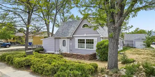 Image 2: Classic exterior architecture and mature trees create a warm and welcoming first impression.