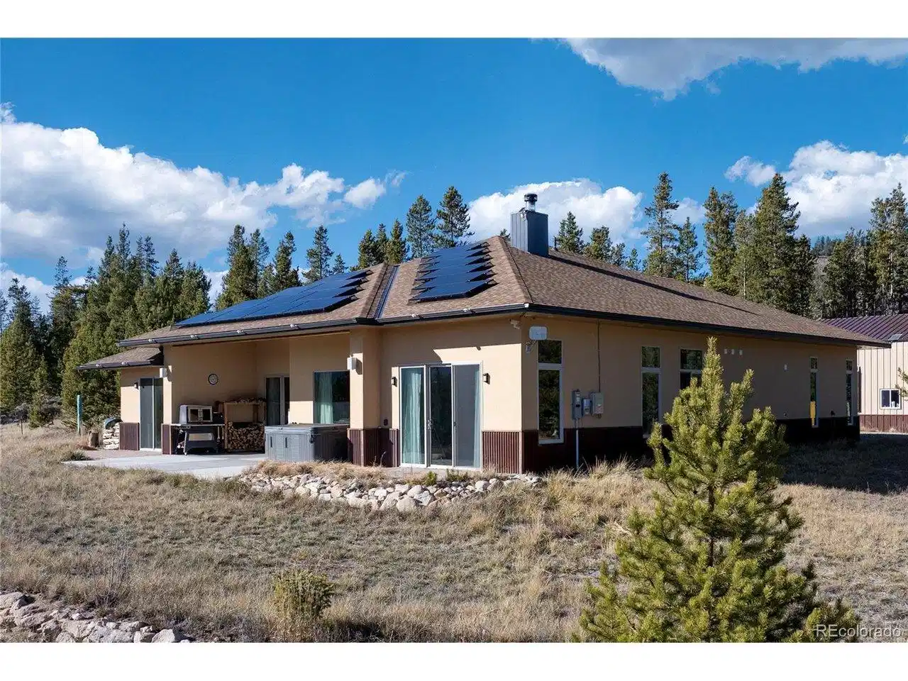 Image 1: Newly built home with solar panels, metal roofing, and Continental Divide mountain views on 35 acres.