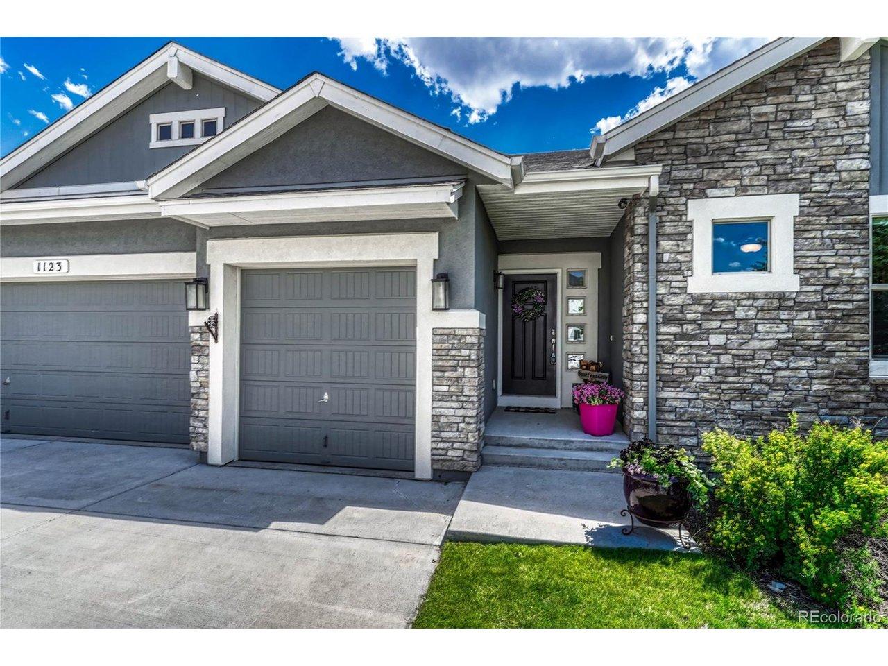 Image 2: The charming stone-accented front entryway features classic stucco detailing and deep eaves, framing a beautiful custom wood-and-glass front door Image 2: The charming stone-accented front entryway features classic stucco detailing and deep eaves, framing a beautiful custom wood-and-glass front door