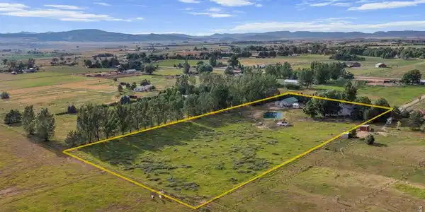 Image 3: Your new Oasis! This view is looking to the NW, emphasizing the 5 acres of pasture. House is surrounded by shade trees in upper right corner Image 3: Your new Oasis! This view is looking to the NW, emphasizing the 5 acres of pasture. House is surrounded by shade trees in upper right corner