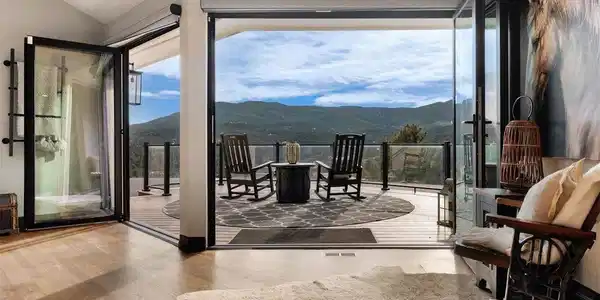 Image 3: NanaWall doors open the space to a south-facing deck, blurring the line between indoors and out and showcasing some of the most impressive views in Soda Creek Image 3: NanaWall doors open the space to a south-facing deck, blurring the line between indoors and out and showcasing some of the most impressive views in Soda Creek