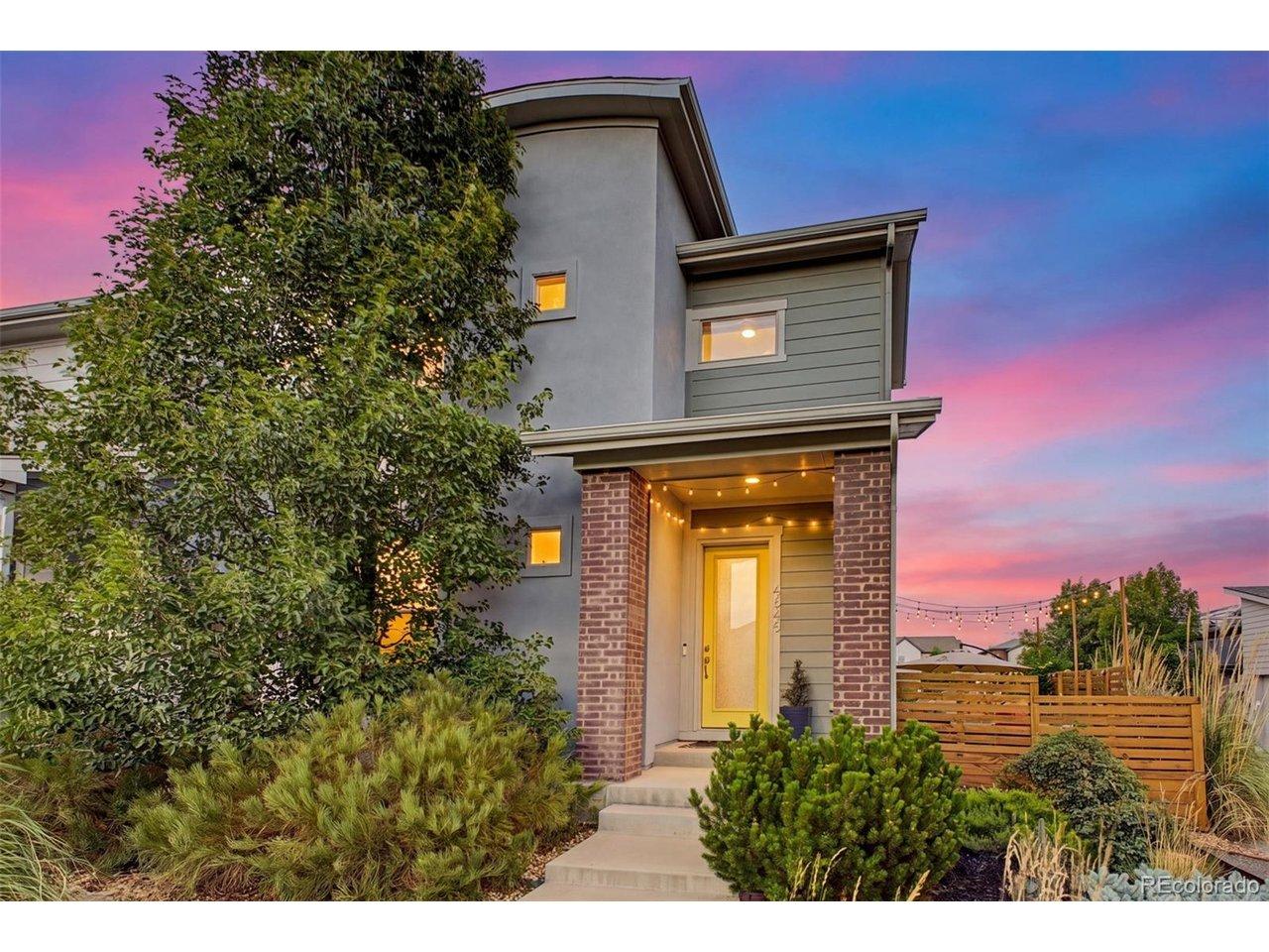 Image 1: Dusk shot highlighting warm interior lighting and vibrant sunset sky behind the home Image 1: Dusk shot highlighting warm interior lighting and vibrant sunset sky behind the home
