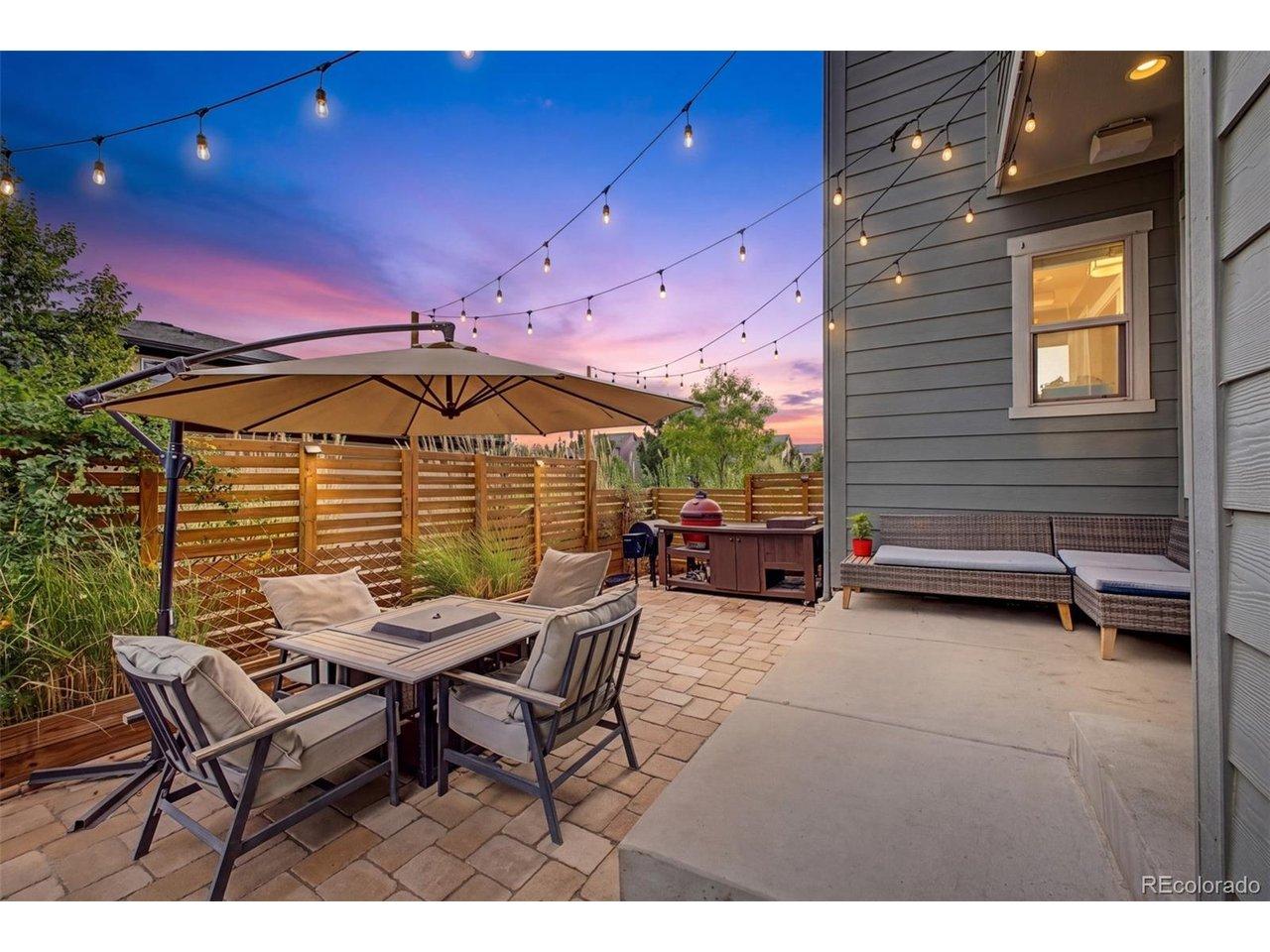 Image 2: Preview: Backyard entertaining area glowing under string lights at dusk Image 2: Preview: Backyard entertaining area glowing under string lights at dusk