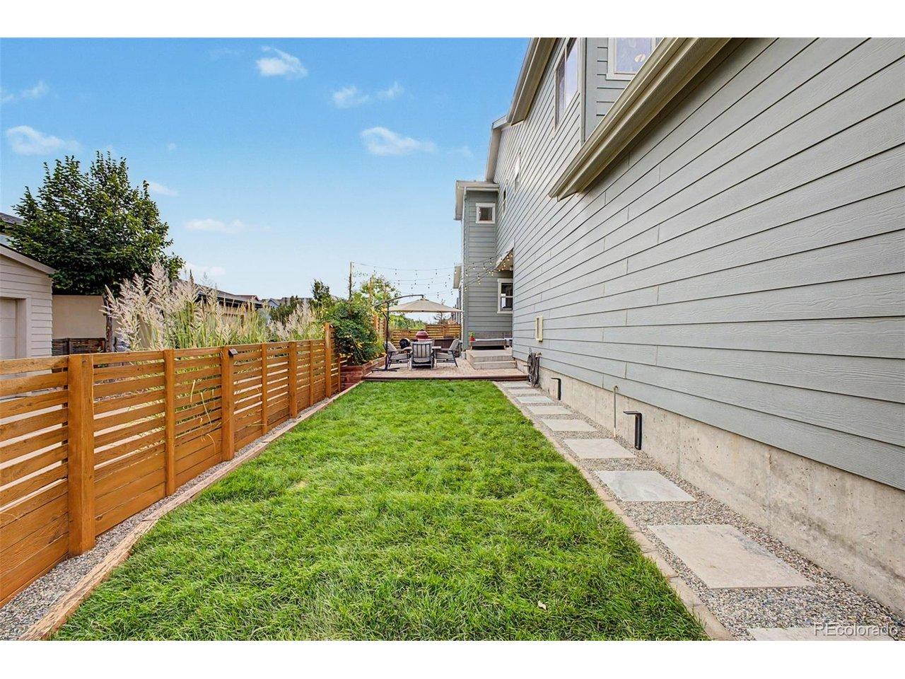 Image 3: Preview of backyard with fresh sod: Pathway leading to backyard patio and outdoor kitchen Image 3: Preview of backyard with fresh sod: Pathway leading to backyard patio and outdoor kitchen