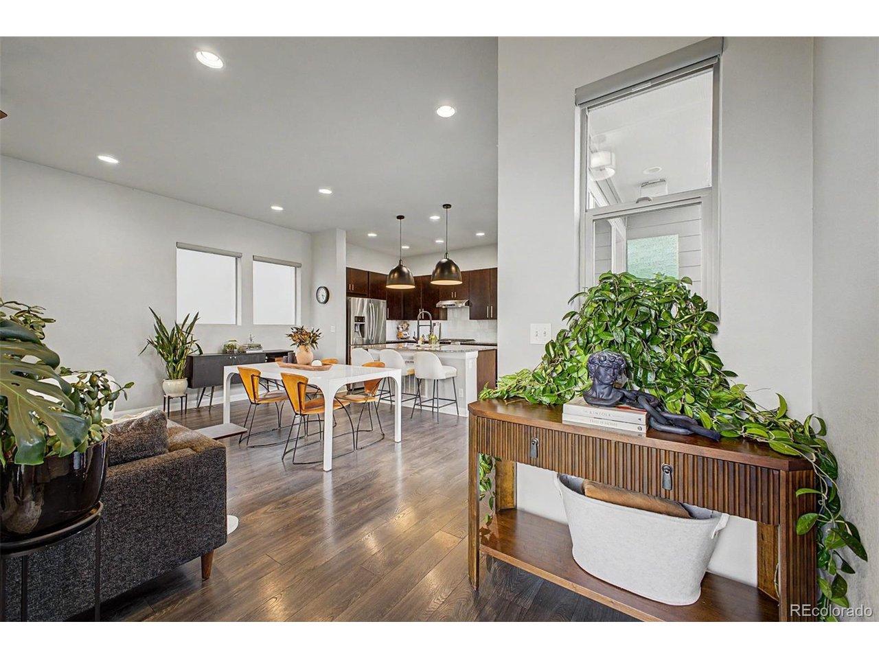 Image 4: Console table vignette with greenery opening into dining and kitchen Image 4: Console table vignette with greenery opening into dining and kitchen