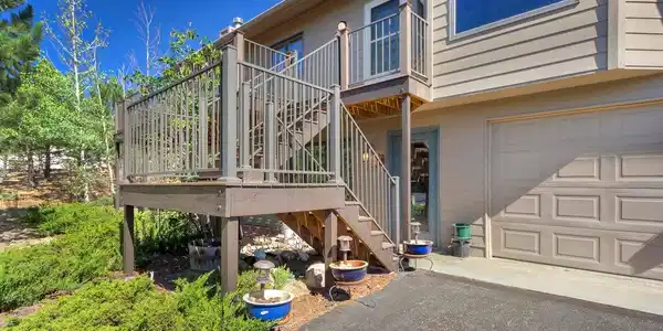 Image 3: Spacious Trex deck provides an inviting outdoor living space with beautiful views of Twin Sisters, Longs Peak, and the surrounding mountains.