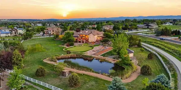 Image 4: Aerial pond view: Aerial view showcasing the pond, grounds, and impressive lot size.