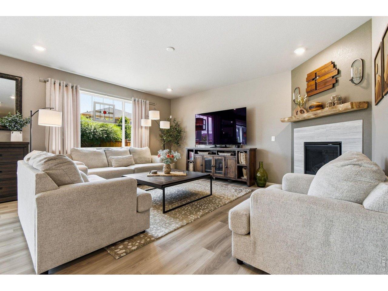 Image 2: Spacious and sun filled living room with elegant fireplace Image 2: Spacious and sun filled living room with elegant fireplace