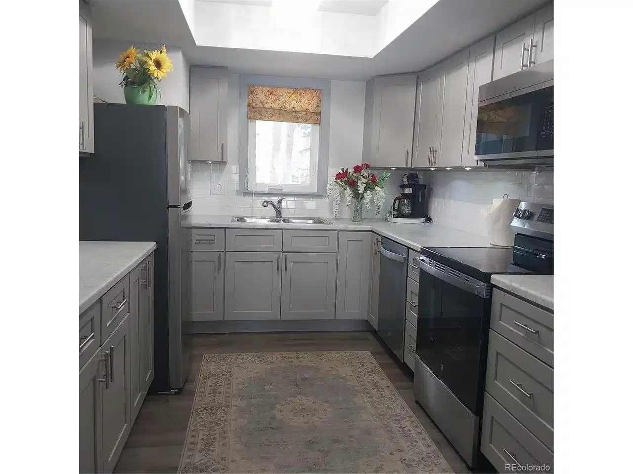 Image 1: flowers in the kitchen with updated lighting