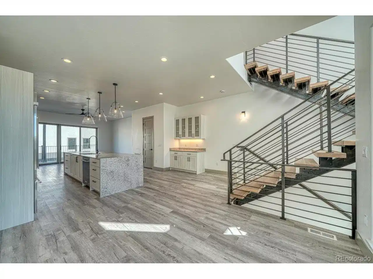 Image 1: Second level living space with open floor plan to dining and living room