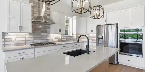 Image 4: Designer kitchen featuring quartz countertops, custom cabinetry, statement lighting, and an oversized island perfect for gathering. Image 4: Designer kitchen featuring quartz countertops, custom cabinetry, statement lighting, and an oversized island perfect for gathering.