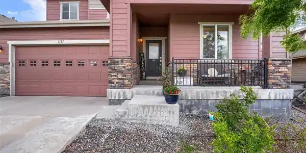 Image 2: Room to park and play - spacious driveway with an attached three-car garage and basketball hoop.