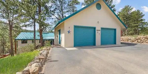 Image 2: 870 SF detached garage (2006) with easily accessed attic storage + an asphalt driveway Image 2: 870 SF detached garage (2006) with easily accessed attic storage + an asphalt driveway