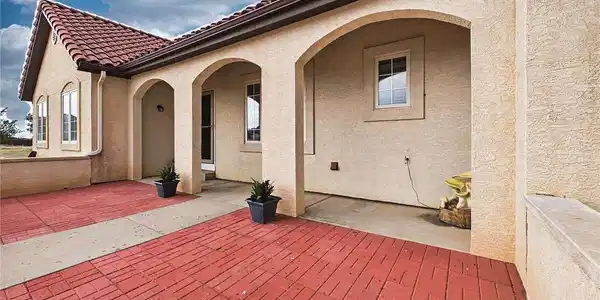 Image 2: Inviting front porch features arched architectural details and ample space to enjoy peaceful outdoor relaxation. Image 2: Inviting front porch features arched architectural details and ample space to enjoy peaceful outdoor relaxation.