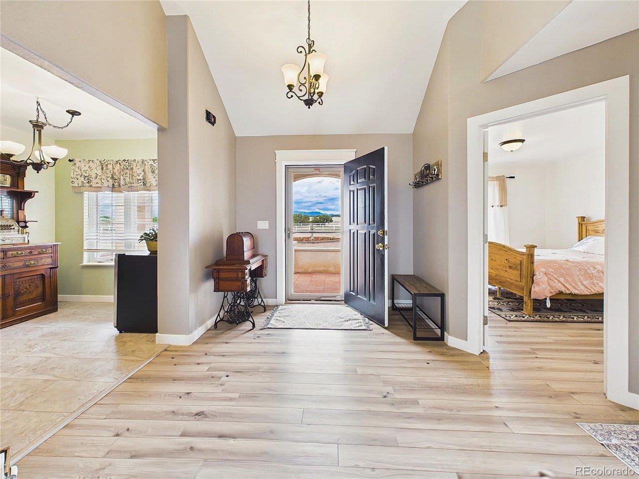 Image 3: Welcoming entryway features vaulted ceilings, updated flooring, and an open layout that immediately highlights the home's spacious feel. Image 3: Welcoming entryway features vaulted ceilings, updated flooring, and an open layout that immediately highlights the home's spacious feel.