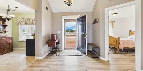 Image 3: Welcoming entryway features vaulted ceilings, updated flooring, and an open layout that immediately highlights the home's spacious feel. Image 3: Welcoming entryway features vaulted ceilings, updated flooring, and an open layout that immediately highlights the home's spacious feel.