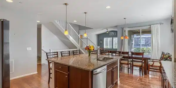 Image 4: The heart of the home - an open kitchen featuring granite countertops, a generous center island, abundant cabinetry, and a walk-in pantry.