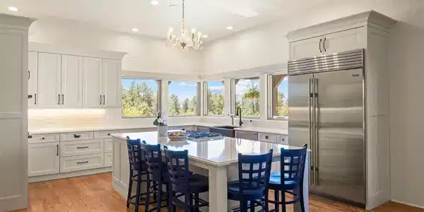 Image 3: The kitchen features Wolf and Sub-Zero appliances, an extra-large center island, quartz countertops, and white cabinetry. Image 3: The kitchen features Wolf and Sub-Zero appliances, an extra-large center island, quartz countertops, and white cabinetry.