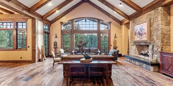 Image 4: Vaulted great room featuring exposed timber beams and open living design Image 4: Vaulted great room featuring exposed timber beams and open living design