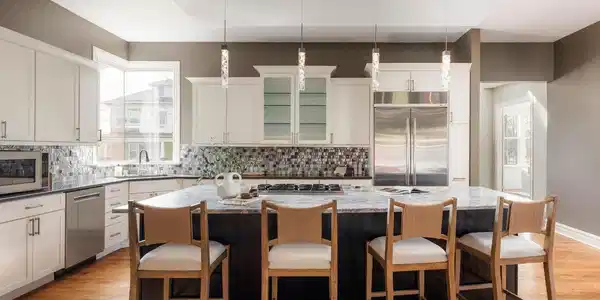 Image 2: The kitchen serves as the heart of the home with a large island, generous counter space, Wolf double ovens, and a walk-in pantry.