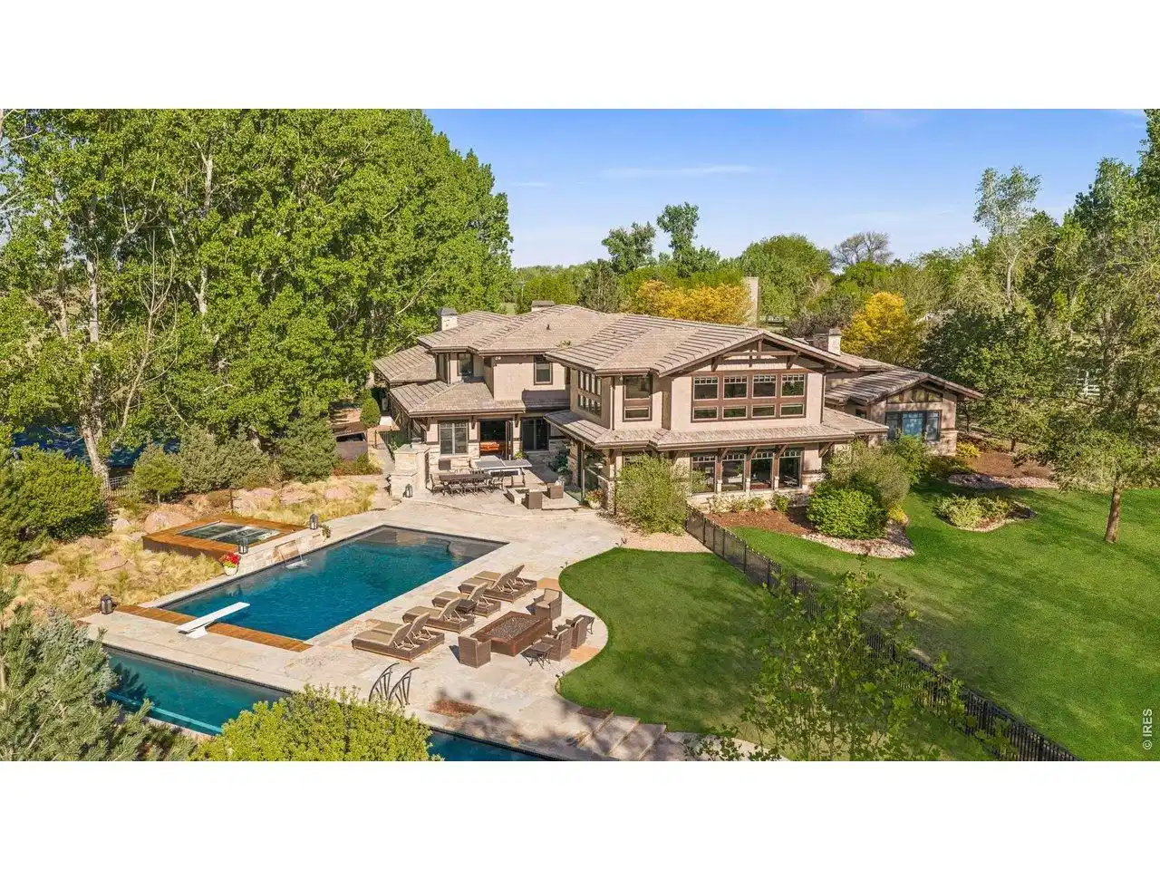 Image 1: Rear exterior with pool, lap pool, hot tub, cold plunge, tennis courts as well as outdoor kitchen Image 1: Rear exterior with pool, lap pool, hot tub, cold plunge, tennis courts as well as outdoor kitchen