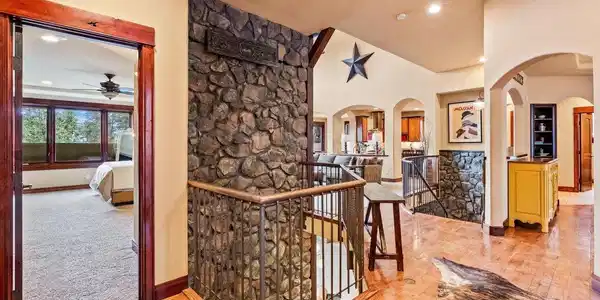 Image 4: Main Level to Basement Stone Waterfall Feature Image 4: Main Level to Basement Stone Waterfall Feature
