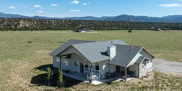 Image 2: Home surrounded by open pasture land