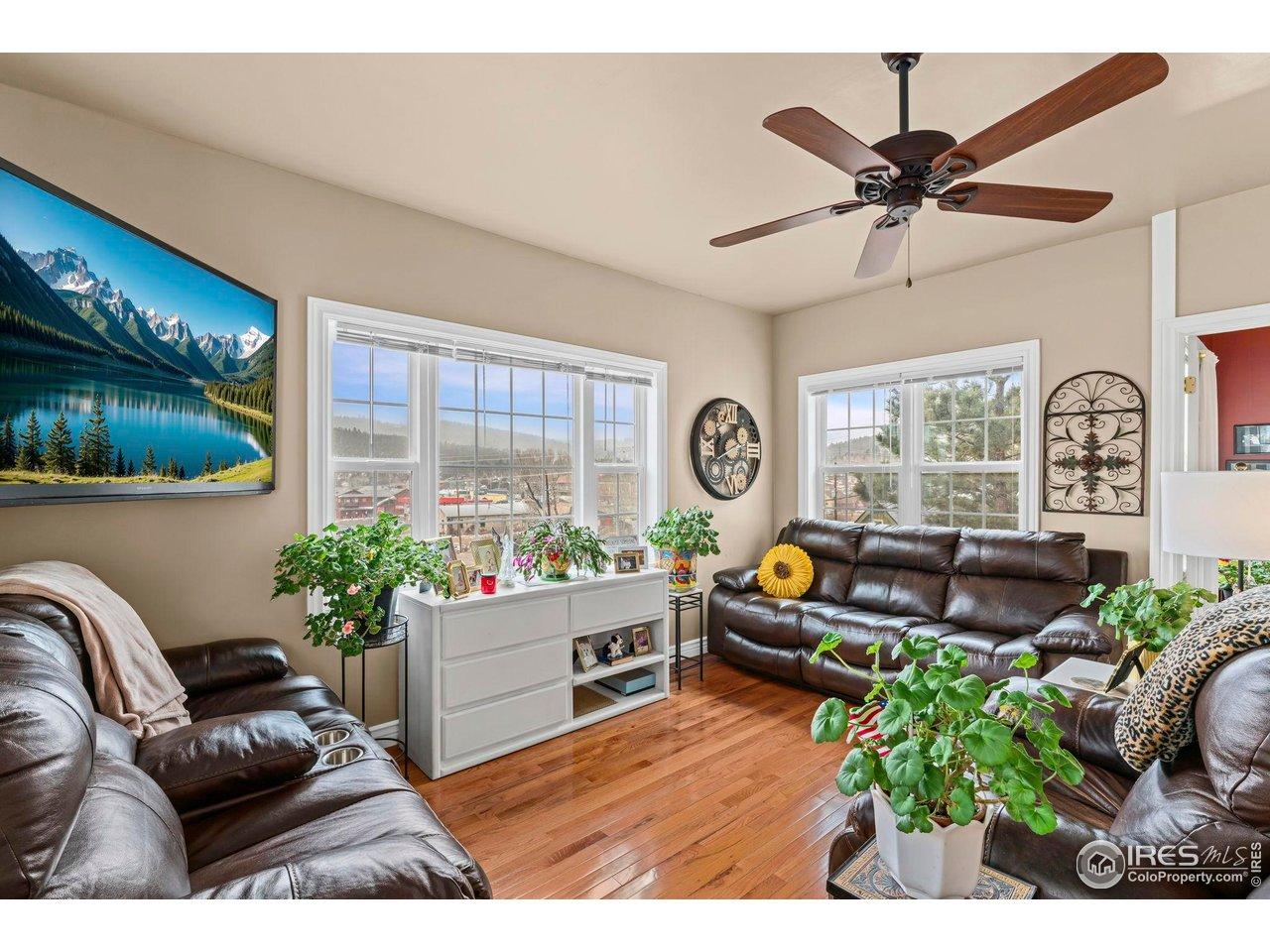 Image 4: Entering thru the covered porch you are welcomed home by a sundrenched living room with southern and eastern views