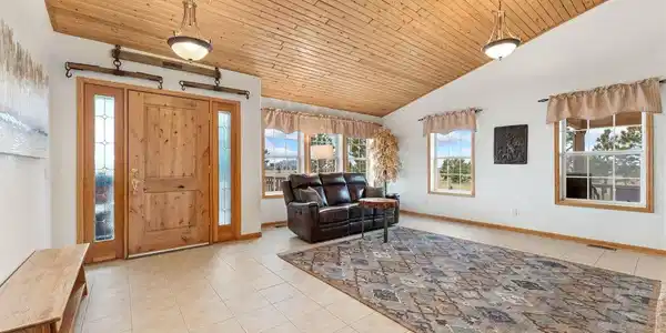 Image 3: Warm wood finishes in the spacious family room