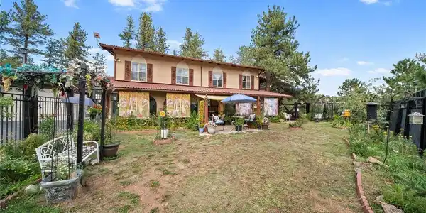 Image 2: Courtyard filled with flowers and color