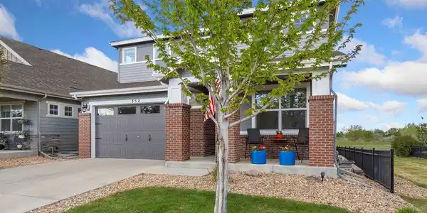 Image 2: Covered Front Porch and Located Next to Community Greenbelt