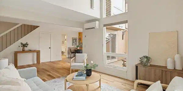 Image 3: Bright living space connects seamlessly to eat in kitchen
