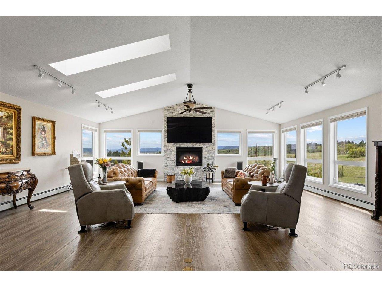 Image 3: The raised ranch layout places all principal living areas - kitchen, dining, great room, and primary suite - on the upper level, where the views are most commanding.