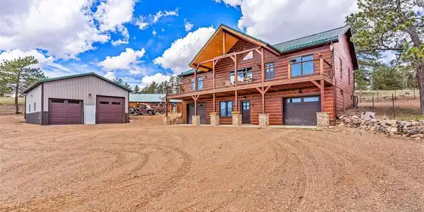 Image 3: Front of home, 2 car attached on each side of basement with entry to home from garages, 2 car detached oversized garage Image 3: Front of home, 2 car attached on each side of basement with entry to home from garages, 2 car detached oversized garage