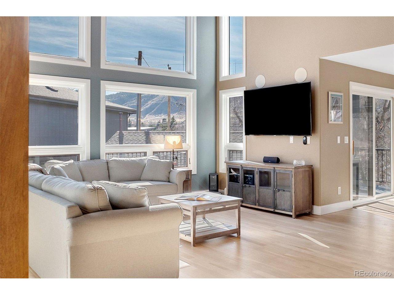 Image 3: Walls of windows, vaulted ceilings, and foothills views create a comfortable and inviting atmosphere.