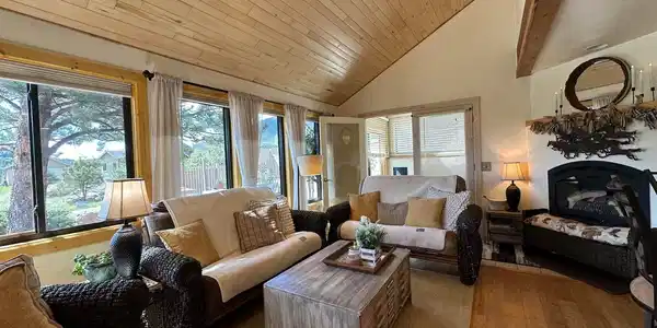 Image 3: Living Room with Gas Fireplace and entrance to sun room