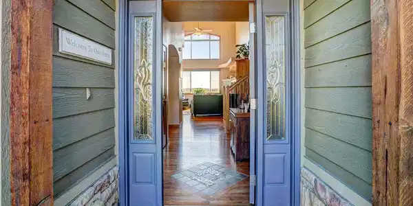 Image 3: Stone and wood accents greet you as you enter from the front,