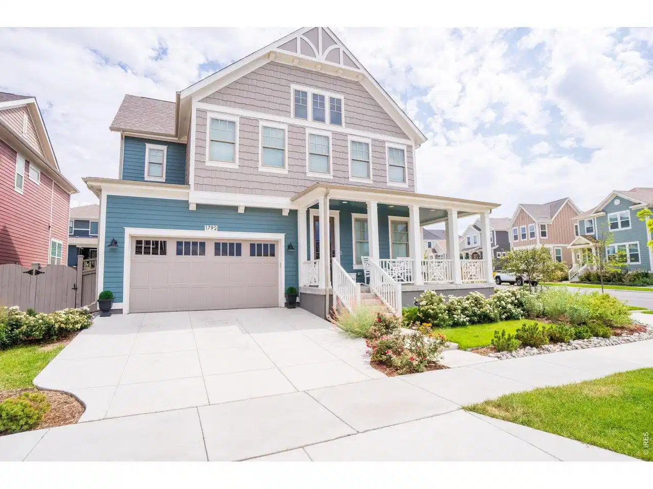 Image 1: Great curb appeal with gorgeous landscaping including rows of roses. Enjoy sunsets from the wraparound front porch on this large corner lot.