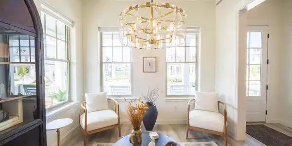 Image 3: Versatile front room great entry for dining, office or sitting room. Greet your guests in style. Chandeliers are from Arhaus