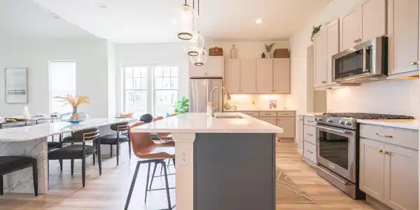 Image 4: The kitchen is light and bright, and a great gathering hub in the center of the home. Complete with a full walk-in pantry, gas cooktop, and abundant cabinet storage.
