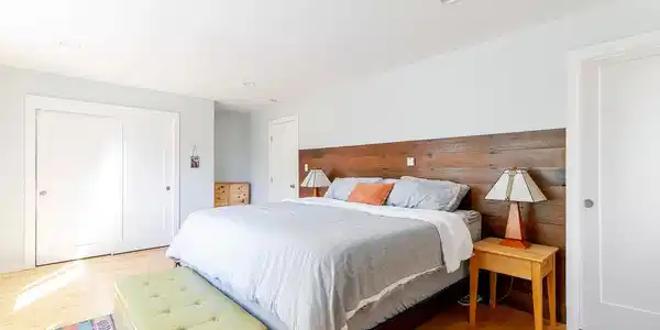 Image 4: Upper level master bedroom with vinyl plank floors, ensuite bathroom and large windows with mountain views