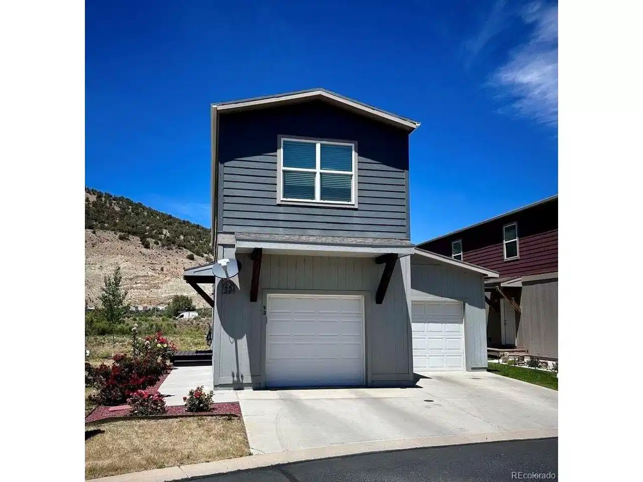 Image 1: Front View, 2 garages, driveway