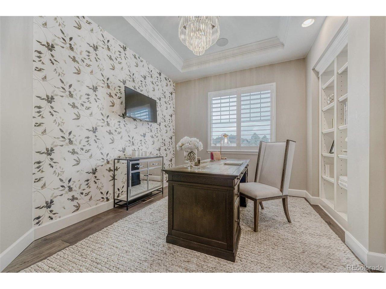Image 4: French doors lead to main level office with built-in book case, coffered ceiling, and custom light fixture. Image 4: French doors lead to main level office with built-in book case, coffered ceiling, and custom light fixture.
