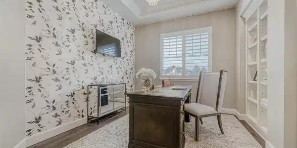 Image 4: French doors lead to main level office with built-in book case, coffered ceiling, and custom light fixture. Image 4: French doors lead to main level office with built-in book case, coffered ceiling, and custom light fixture.