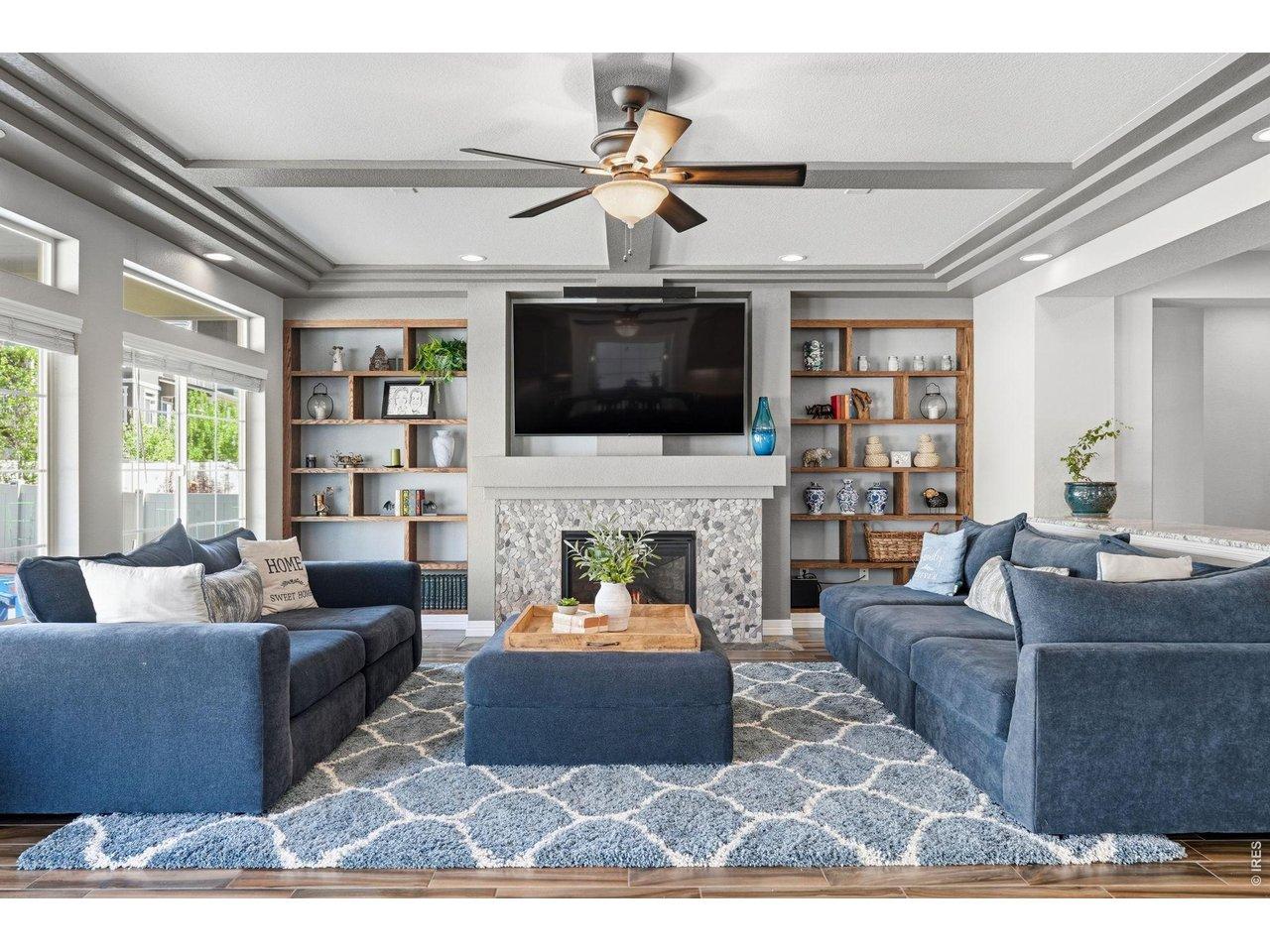 Image 3: Inside, the main living spaces immediately stand out with natural light, built-in shelving, and a fireplace that anchors the room. Image 3: Inside, the main living spaces immediately stand out with natural light, built-in shelving, and a fireplace that anchors the room.