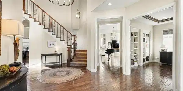 Image 4: Grand entrance welcomes you with a mahogany front door, soaring ceilings, chandelier & double sided staircase. Image 4: Grand entrance welcomes you with a mahogany front door, soaring ceilings, chandelier & double sided staircase.