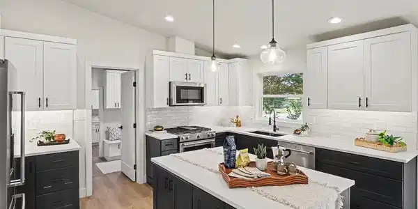 Image 4: At the heart of the home, the elevated kitchen pairs contemporary shaker cabinetry and quartz countertops with a premium KitchenAid appliance package. Image 4: At the heart of the home, the elevated kitchen pairs contemporary shaker cabinetry and quartz countertops with a premium KitchenAid appliance package.