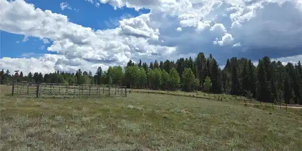 Image 3: Expansive open field with a permanent metal corral. Image 3: Expansive open field with a permanent metal corral.