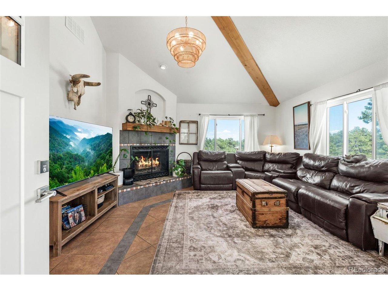 Image 4: Vaulted ceilings and a wood burning fireplace set the tone for the whole main level. Image 4: Vaulted ceilings and a wood burning fireplace set the tone for the whole main level.
